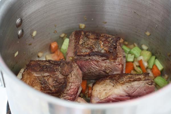 browned short ribs and vegetables